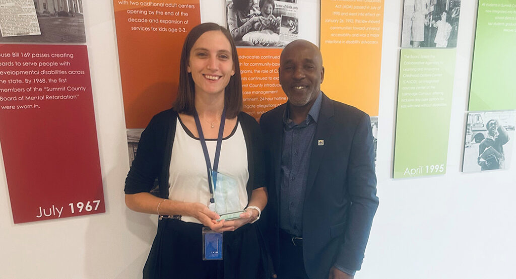 Summit DD community engagement coordinator, Amy Kelly-Lancki, smiling while receiving a community award from the United Way.
