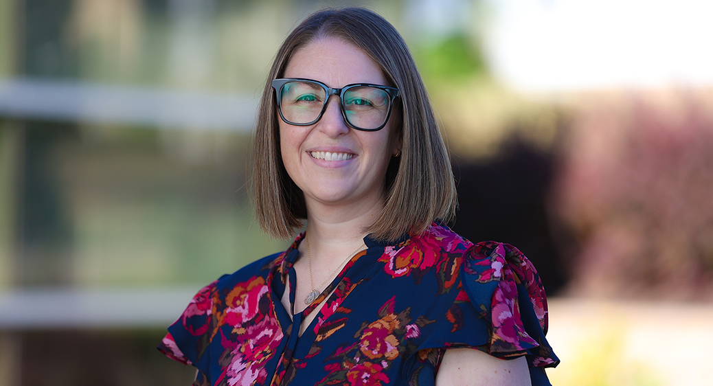 New staff member, Nicole Elliott, smiling for a photo outside of the Summit DD offices.