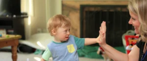 woman and young child giving each other a high five