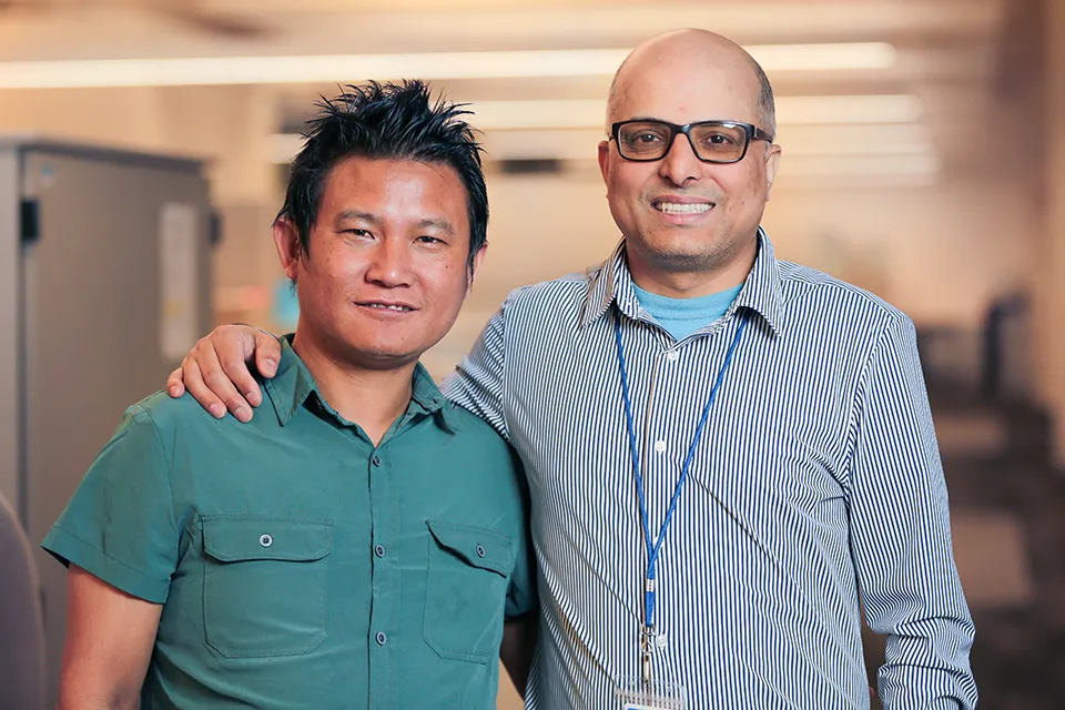 Man and his SSA, Damodar, smiling and posing for a photo