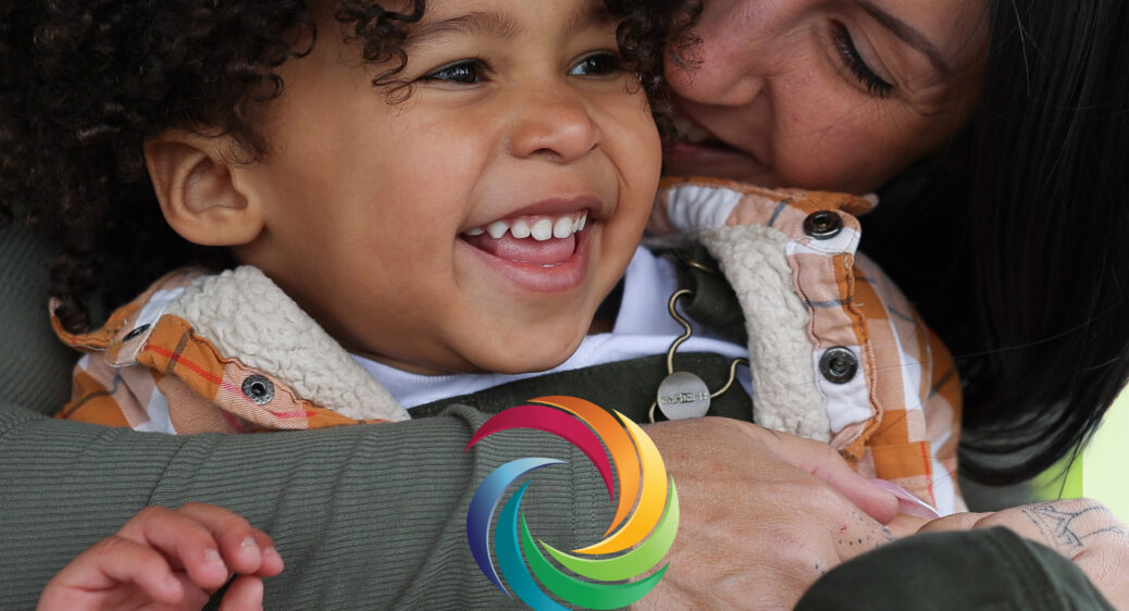 Image of 2026 DRAFT Action Plan showing a mom hugging her toddler son - both with big smiles. The Words: 2026 Summit DD Draft Action Plan are written at the bottom of the page along with the colorful Summit DD icon from the Summit DD logo