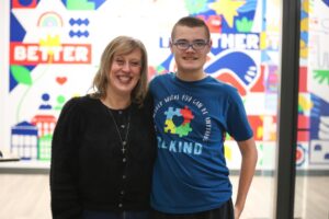 Summit DD staff member posing with a young man at the 2025 Autism Summit