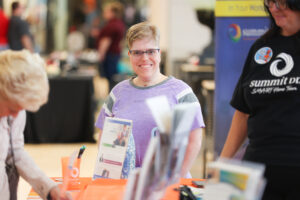Summit DD team member sharing information at a community event.