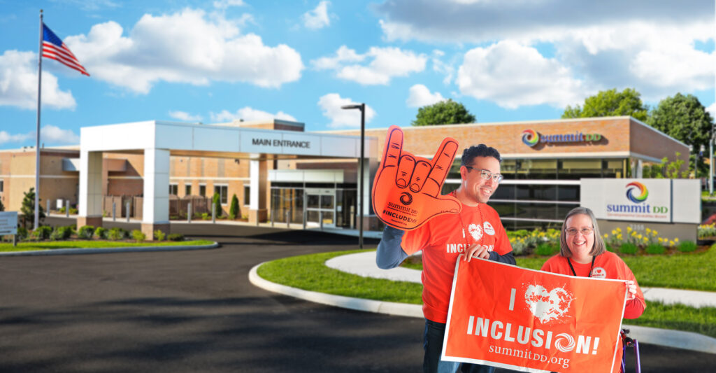 Two smiling Summit DD team members standing in front of the Summit DD office building in downtown Cuyahoga Falls.