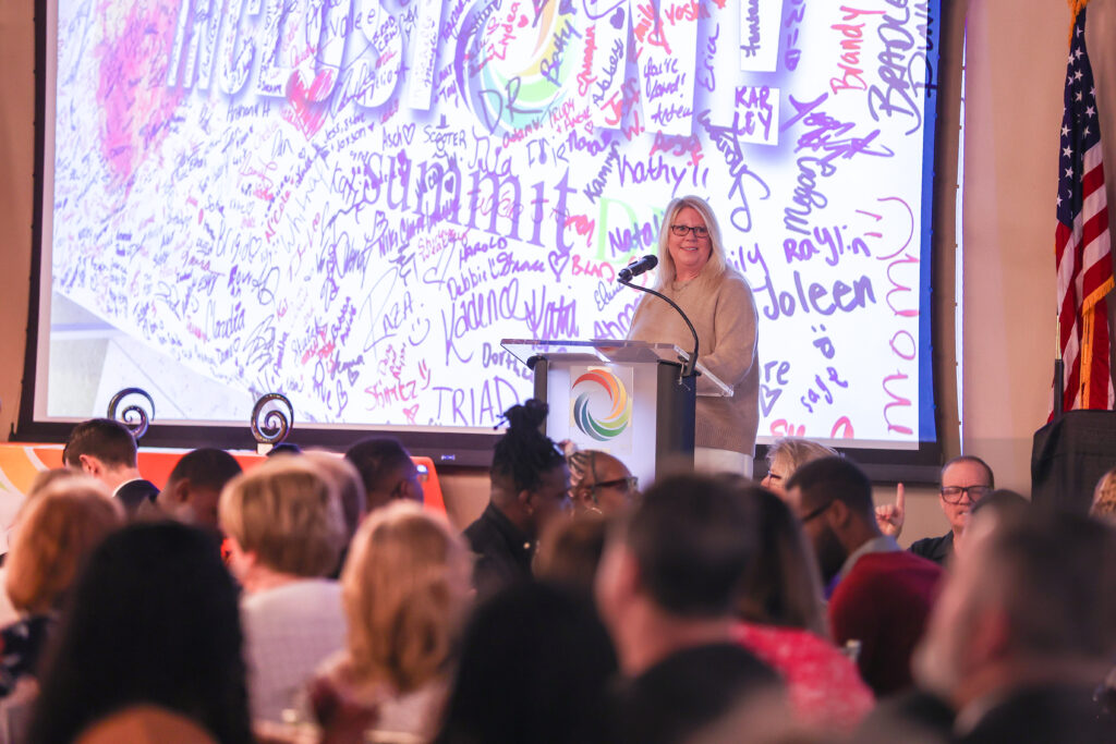 Summit DD Superintendent, Lisa Kamlowsky presenting at the podium during Summit DD's 2026 Community Breakfast