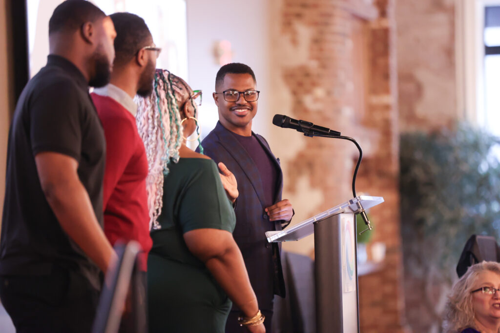 Louisa Ridge representative accepting award at podium