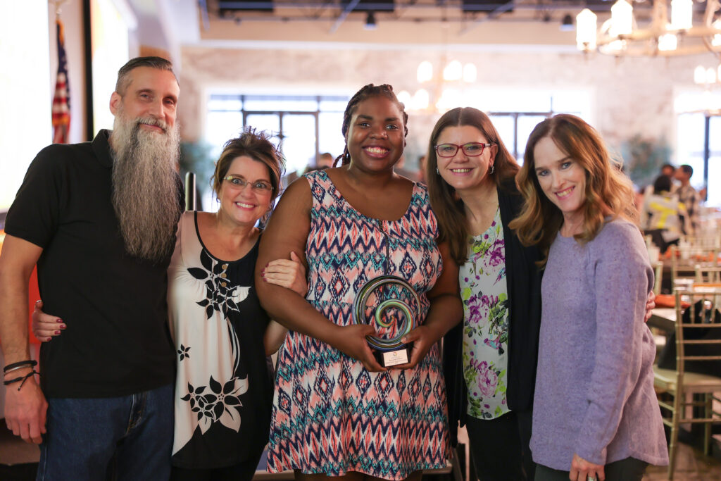 Group posing for photo with Carlene Weaver Award winner, Rosemene