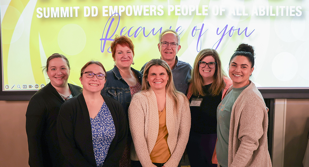 Large group of smiling attendees at the Summit DD Appreciation Breakfast.