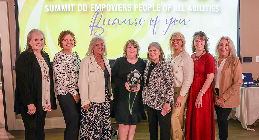 Large group of smiling attendees at the Summit DD Appreciation Breakfast.