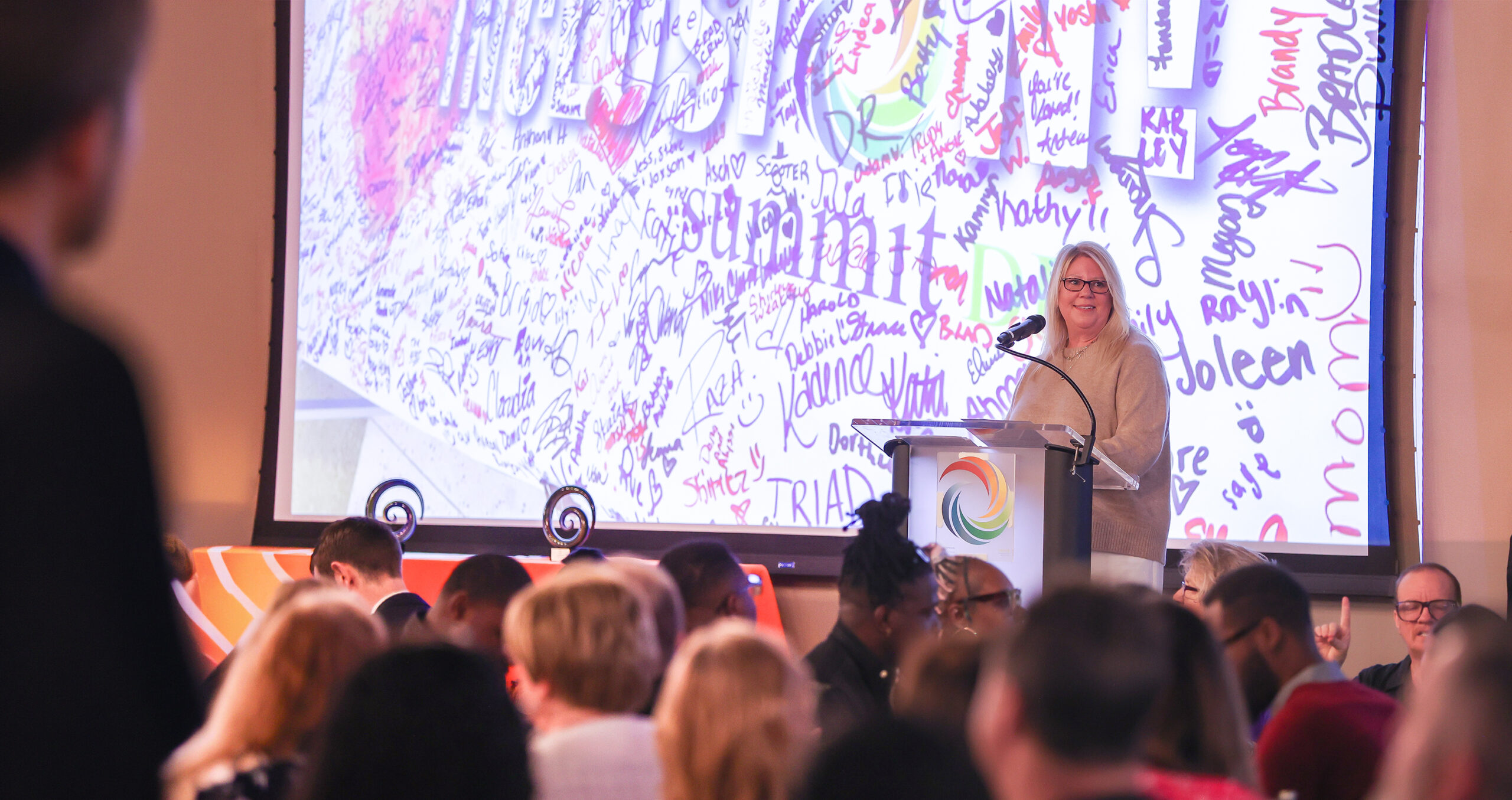 Summit DD Superintendent, Lisa Kamlowsky presenting at the podium during Summit DD's 2026 Community Breakfast