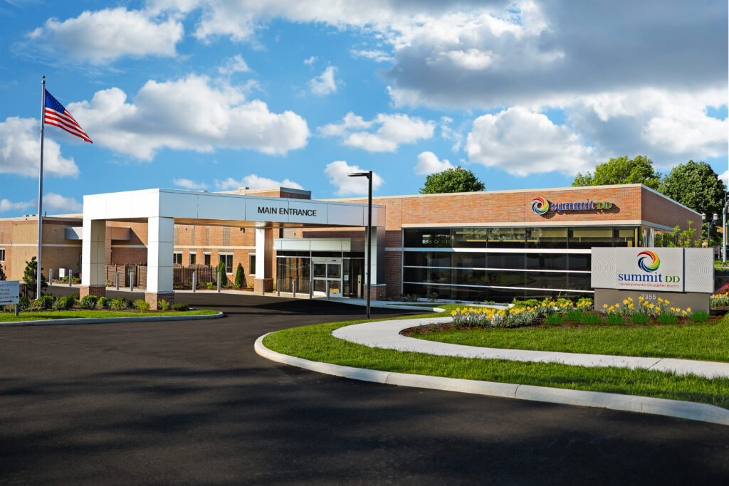 Outdoor photo of Summit DD Cuyahoga Falls center. Blue sky. White clouds.