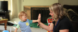 Young boy receiving EI services from Developmental Specialist.