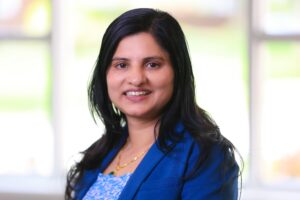 Smiling outdoor portrait of Summit DD staff member Parwati Regmi.
