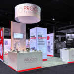 custom island exhibit with vector lighted tower and LED lighted graphics for Process Technology at SUR/FIN 2025