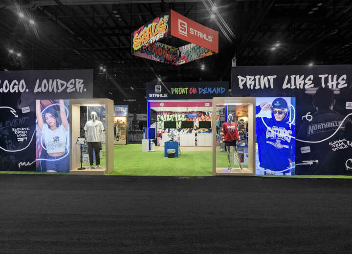 Custom island double deck booth with lightboxes, modern graphics and retail product displays for STAHLS' at Printing United 2025