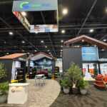 Custom island double deck exhibit for Green Corp American Plastics at Inspired Home 2026