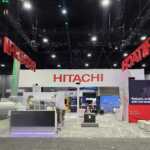 Custom exhibit island trade show booth for Hitachi at IEEE 2026