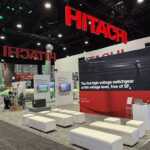 Custom exhibit island trade show booth for Hitachi at IEEE 2026