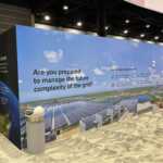 Custom exhibit island trade show booth for Hitachi at IEEE 2026