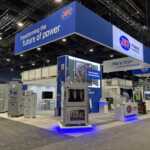 Custom island double deck rental exhibit for JST at IEEE 2026