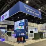 Custom island double deck rental exhibit for JST at IEEE 2026