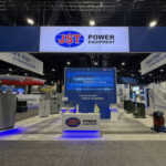 Custom island double deck rental exhibit for JST at IEEE 2026