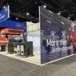 Custom island double deck rental exhibit for JST at IEEE 2026