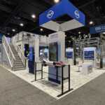 Island booth custom build double deck rental exhibit for PLP at IEEE 2026