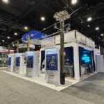 Island booth custom build double deck rental exhibit for PLP at IEEE 2026
