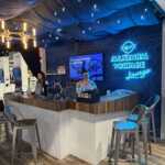 Island booth custom build double deck rental exhibit for PLP at IEEE 2026
