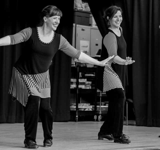 Marsha and Augie of Footworks dancing with tap shoes on stage at Maryland City Elementary