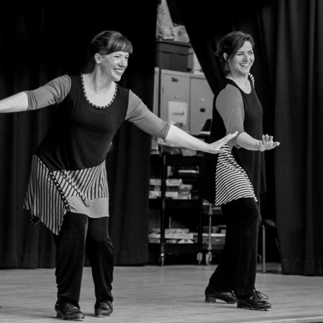 Marsha and Augie of Footworks dancing with tap shoes on stage at Maryland City Elementary