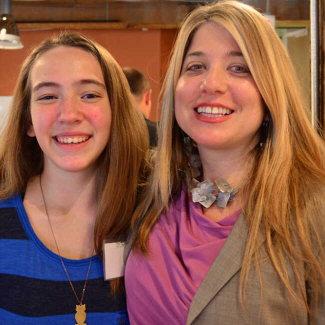 Stacie Sanders Evans posing for a photo with Colette, a high school student and Impact Breakfast speaker