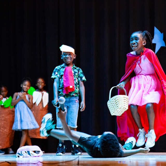 Children performing their own version of Little Red Riding Hood