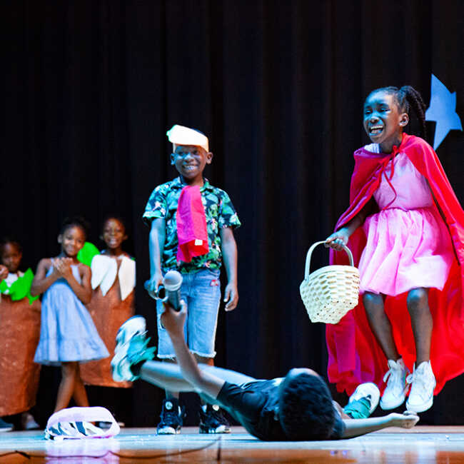 Children performing their own version of Little Red Riding Hood