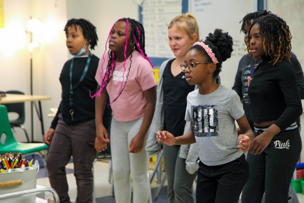 Students standing, looking ahead for direction.