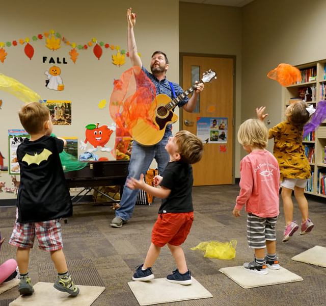 Kevin Alan Brown entertains a class of children