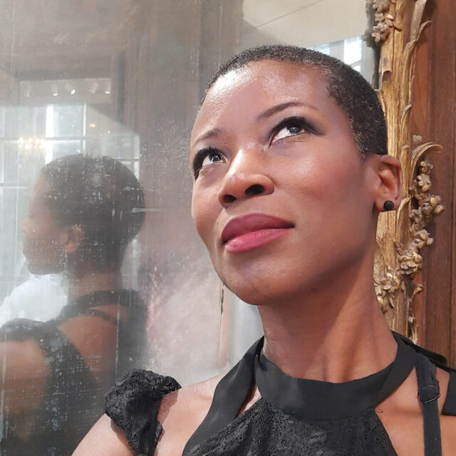 Ambo Tazanu poses in front of a mirror.