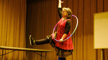Michele Minnick poses with a hula hoop onstage.