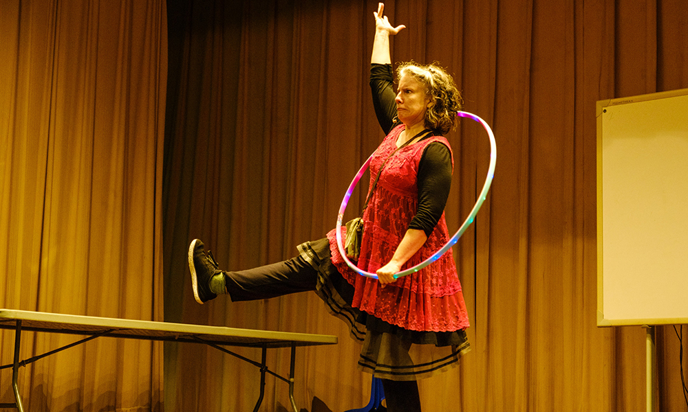 Michele Minnick poses with a hula hoop onstage.