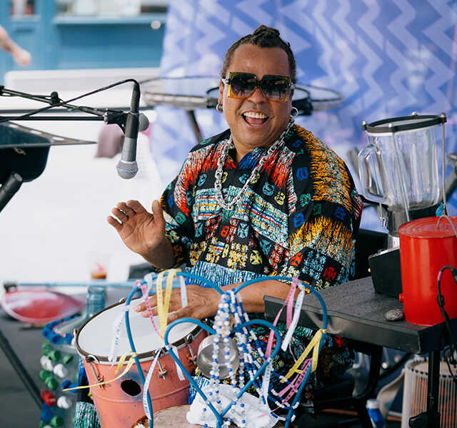 Dendê Macêdo plays the drums