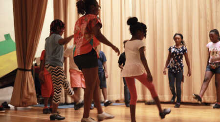 Quynn Johnson shows students how to use their feet to tap.