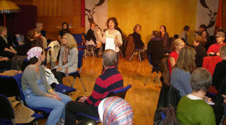 Noa Baum speaks to a group of adults during a professional development workshop.