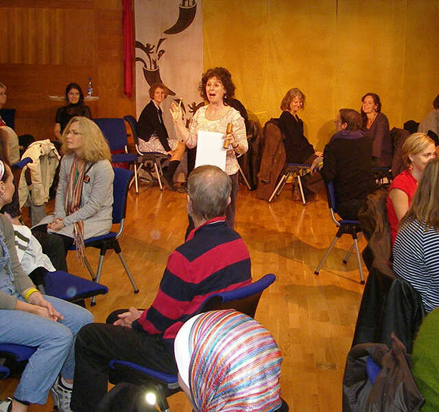 Noa Baum speaks to a group of adults during a professional development workshop.