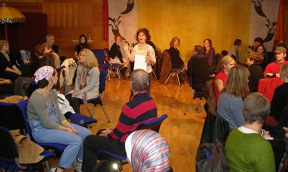 Noa Baum speaks to a group of adults during a professional development workshop.