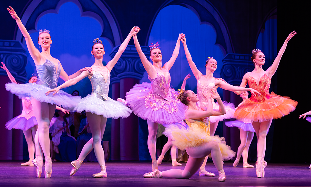 A group of ballet dancers in costume take a bow
