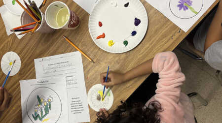 Students explore color with paint during a workshop with Mikela Thrasher