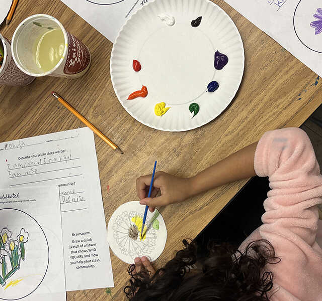 Students explore color with paint during a workshop with Mikela Thrasher