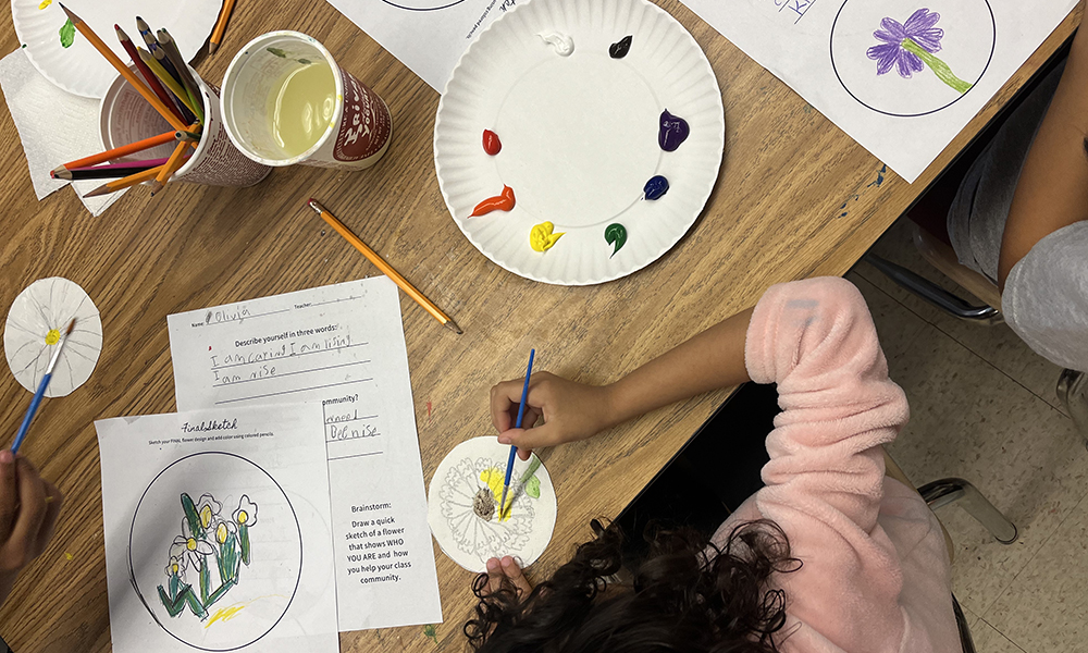 Students explore color with paint during a workshop with Mikela Thrasher