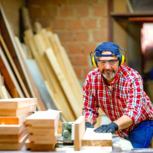 man using table saw needs a table saw cover to prevent rust and corrosoin